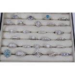 Ring display box containing twenty seven contemporary silver and gem set dress rings