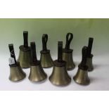 Set eight graduated hand bells with leather strap handles