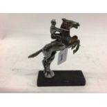 Chromium plated Desmo car mascot in the form of a jockey on horse back, 15cm in height (excluding ba