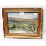 A gilt framed small watercolour, depicting a rural landscape with pool and fence in foreground