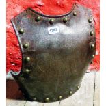 An antique cavalry troopers iron backplate with brass rivets