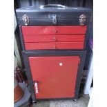 A two part painted metal tool storage unit comprising cabinet, three drawers and lift top