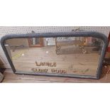 A vintage painted wood framed dome top mirror with remains of text to plate Ladies Cloak Room and