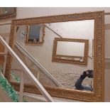 A large ornate gilt framed bevelled oblong wall mirror