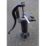 A reproduction cast iron garden pump