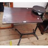 A late Victorian cast iron framed bed table with tilting top and circular side surface - a/f