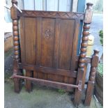 A pair of early 20th Century oak single bed ends with fielded panels and flanking bobbin turned