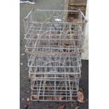 Three vintage metal stacking milk crates