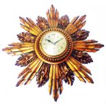 An early 20th Century gilt wood framed starburst wall timepiece with English eight day movement