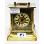 A late 19th Century brass and glazed case carriage style alarm clock with American musical movement