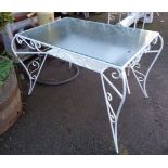 A 94cm painted wrought iron framed conservatory table with glass inset top - small chip