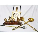 Four Victorian horse brass terrets set on a wooden base, two brass ladles, and a trivet, etc.