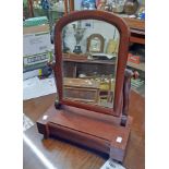 A late Victorian mahogany framed platform dressing table mirror with arched plate and drawer under