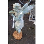 A painted cast iron standing fairy holding a leaf