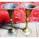 A pair of brass trumpet vases with remains of silver plated finish