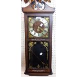 A President polished wood cased wall clock with visible pendulum and gong striking movement