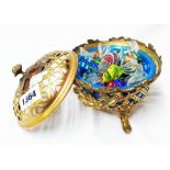 A pierced brass pot pourri containing a selection of blown glass sweets