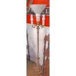 A modern brass and metal standard lamp with three candle style sconces under main light -
