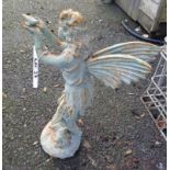 A painted cast iron standing fairy holding a bird