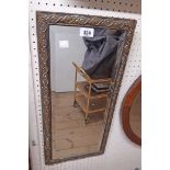 A small brass clad framed bevelled oblong wall mirror