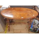 A 1.04m Victorian walnut quarter veneered oval topped centre table, set on turned standard ends with