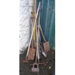 A selection of long handled garden tools, two shovels and a fork, etc.