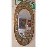A vintage Scottish Arts & Crafts Celtic design embossed brass clad framed bevelled oval wall mirror