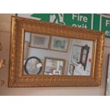 A 50cm wide reproduction gilt framed oblong wall mirror