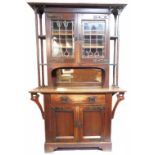 A 1.38m early 20th Century oak Arts and Crafts two part sideboard with decorative applied