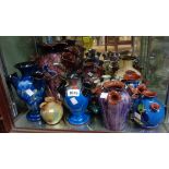 Twelve Torquay pottery tulip or udder vases including Watcombe, Daison, Longpark, etc.