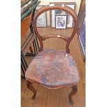 A set of four Victorian mahogany balloon back bedroom chairs with faded printed upholstery, set on