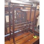 A late Victorian mahogany double towel rail with flanking scroll top