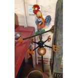 A modern painted cast iron weather vane with cockerel top