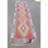 A Middle Eastern flat weave runner with geometric design on blue main - cut in two