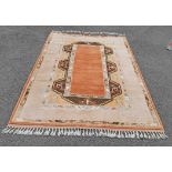 A modern Anatolian wool rug with central terracotta medallion on oatmeal ground within a stylized