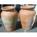 A pair of modern moulded terracotta vase form planters