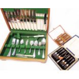 An oak canteen containing a part set of stainless steel cutlery - sold with a cased silver plated