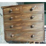 A 19th Century mahogany chest of drawers - front legs detached, the whole in need of restoration