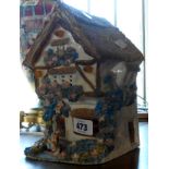 A hand made pottery night light in the form of a Bavarian cottage