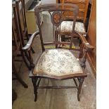 An Edwardian inlaid effect stained walnut framed elbow chair, set on slender turned and swept