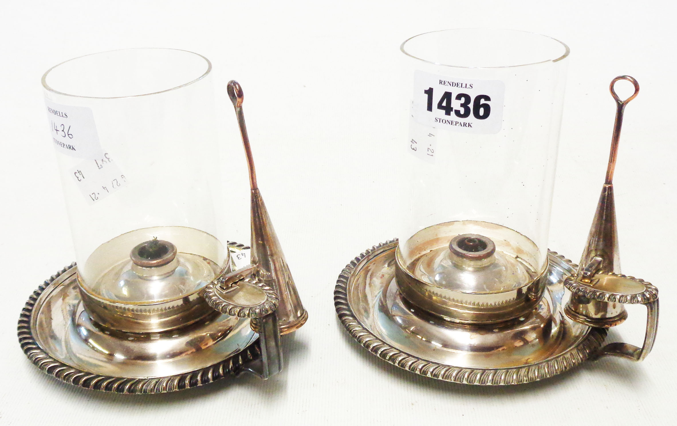 A pair of silver plated oil wick chambersticks with cylindrical glass shades and integral snuffers