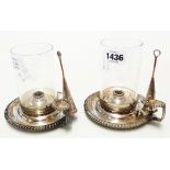 A pair of silver plated oil wick chambersticks with cylindrical glass shades and integral snuffers