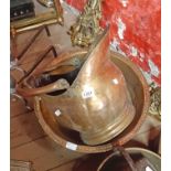 A brass coal helmet and a large brass pan