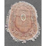 A small oval Chinese wash wool rug