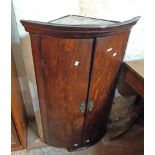 A 66cm late Georgian mahogany wall hanging bow front corner cabinet with shelves enclosed by a