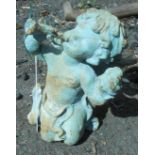 An iron garden fairy holding a trumpet with painted finish