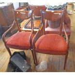 A pair of reproduction mahogany framed elbow chairs with swept armrests and corduroy upholstered