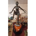 A modern bronzed Art Deco style lady dancing with a hoop