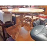 A 1.22m diameter 20th Century varnished pine pedestal dining table, set on massive turned pillar and