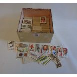 A tin containing a large quantity of sets and part sets of loose cigarette cards, including Gallaher